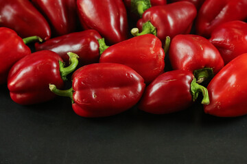 Red peppers on black background
