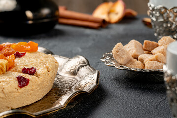 Halva with dried fruits on arabic dishware