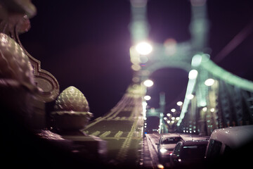 cars driving over a bridge at night, out-of focus nice bokeh lights, selective focus - 399971019