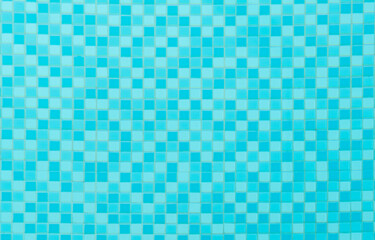 Blue pool tiles mosaic ceramics pattern under clear blue water, swimming pool tiles background