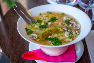 Noodle Bowl With vegetables and dumplings. Close up of a bowl Chinese style on wooden background .