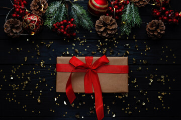 Christmas black background, Christmas balls, branches and red ribbon decoration gifts. New Year 2021 Soft Selective Focus.