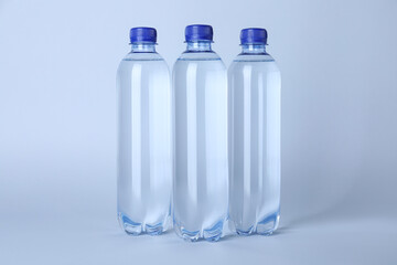 Plastic bottles with water on white background