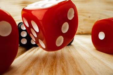 Red and black dice cubes on wooden background