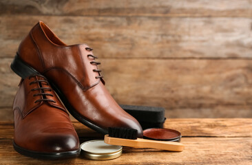 Shoe care products and footwear on wooden table. Space for text - Powered by Adobe
