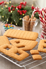 Parts of gingerbread house on wooden table, closeup