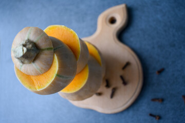 Sliced pumpkin with spices on a cutting board