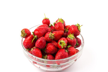 Fresh ripe delicious strawberries in a glass bowl on white background