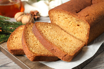 Fresh sliced gingerbread cake on wooden cutting board, closeup