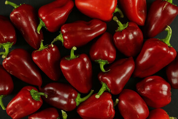 Red peppers on black background