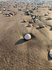 Beautiful pebbles on the sand, beach background