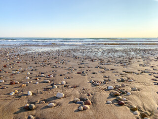 Sand beach with some pebbles and se view background