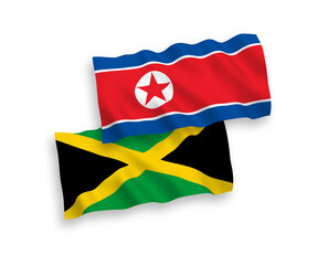 National vector fabric wave flags of North Korea and Jamaica isolated on white background. 1 to 2 proportion.