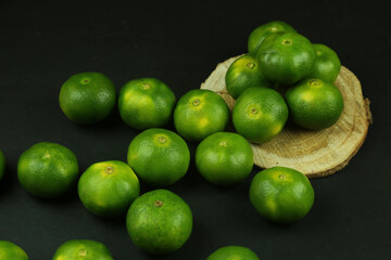 Green sweet tangerines growing with background
