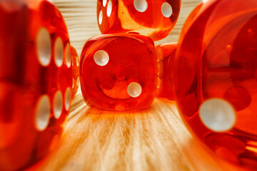 Red dice tossed on wooden background close up