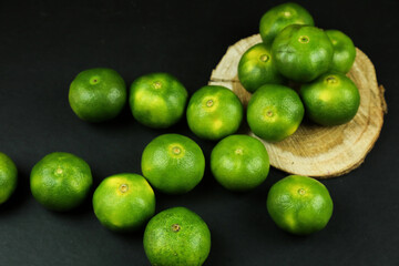 Green sweet tangerines growing with background