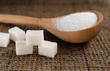 Pieces of lump sugar on burlap. granulated sugar close-up. Refined sugar. Sugar