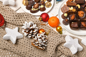 sweet food top view background for merry christmas or new year holiday decoration - chocolate candies, tangerines, cookies on white wood
