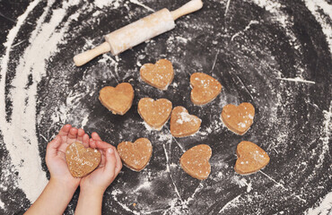 Homemade hearts cookies on a black background 