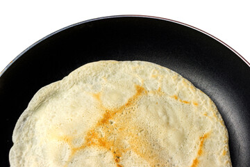 Top view of fried crepe in the pan isolated in white.