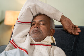 Asian senior man having nice sleep on bed at home - concept of better sleep or nap and healthy lifestyle.