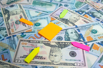 Blank note paper close-up on dollar banknote background. Place your message on the notebook page.
