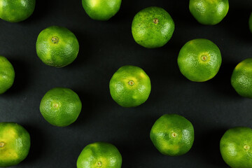 Green sweet tangerines growing with background