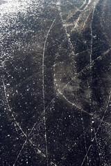background of the surface of patterned black ice of a frozen lake