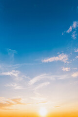 vertical Sky blue and orange light of the sun through the clouds in the sky