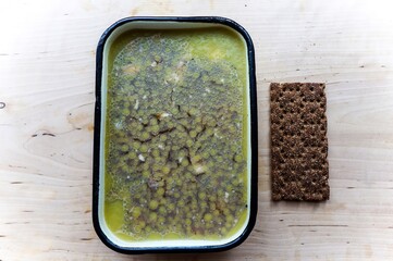 Aspic in a metal dish and a piece of rye diet bread