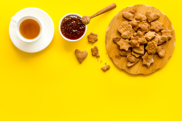Chocolate cookies flat lay with berry jam and tea