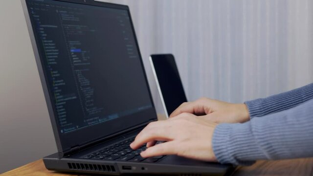 Female Developer Develops a Web Application, Close-up. The Programmer Writes The Program Code Script. Debugger Encodes. 