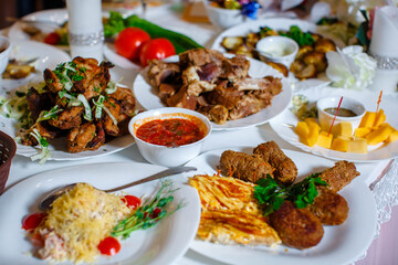 Catering. Restaurant table with food. There is a huge amount of food on the table. Plates of food. Time for lunch, dinner.