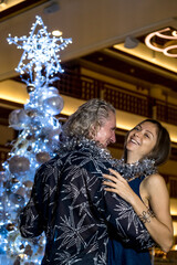 Romantic mature couple dancing by Christmas tree. Winter holidays concept