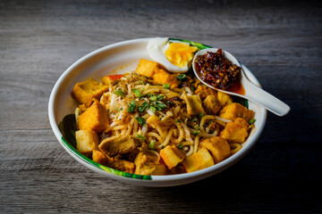 Mee Kari or Curry Mee with wooden background.