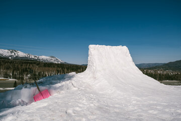 quarter pipe for snowboard outdoor near ski resort in mountains. Sunny winter day
