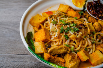 Mee Kari or Curry Mee with wooden background closeup right alignment.
