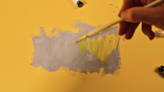 Panton 2021 trend in yellow and gray colors. Abstract image with gray paints on a yellow background. High quality 4k footage