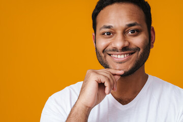 Asian happy unshaven man smiling and touching his chin