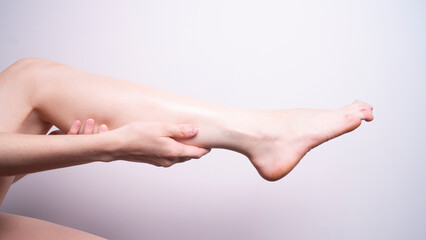 Obraz na płótnie Canvas massage of leg muscles with hands, leg pain