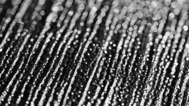 4K Dramatic texture of abstract dark metal background. Textured metallic black. Rotating macro extreme close up of interesting and cool monochrome pattern resembling evil looking alien skin.