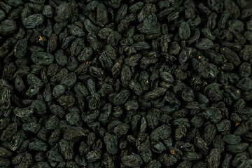 Dried raisins on black background