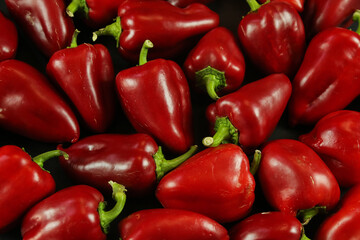 Red peppers on black background