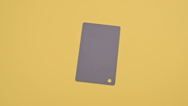The main color of 2021 on cards. Trendy Panton gray on a yellow background. Stopmotion. High quality FullHD footage. High quality FullHD footage
