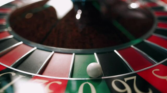 Casino roulette in motion. The spinning wheel ball. The ball hit the zero
