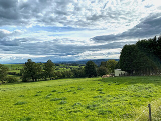 Obraz premium Country landscape, with trees, fields, and a cloudy sky near, Whitehall Road, Bradford, UK