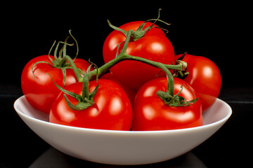 juicy ripe tomatoes on a white plate close up