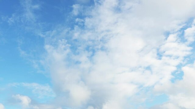 The sky of a cloudy day seascape. The clouds float quickly across the blue sky. Time-lapse cloudy sky.