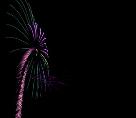 Bright purple and green trail of light up to a exploding splash of color. Left side of image,...