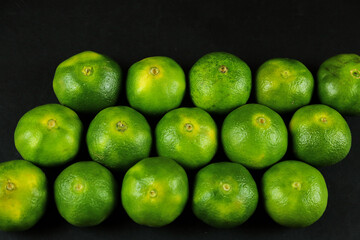 Green sweet tangerines growing with background